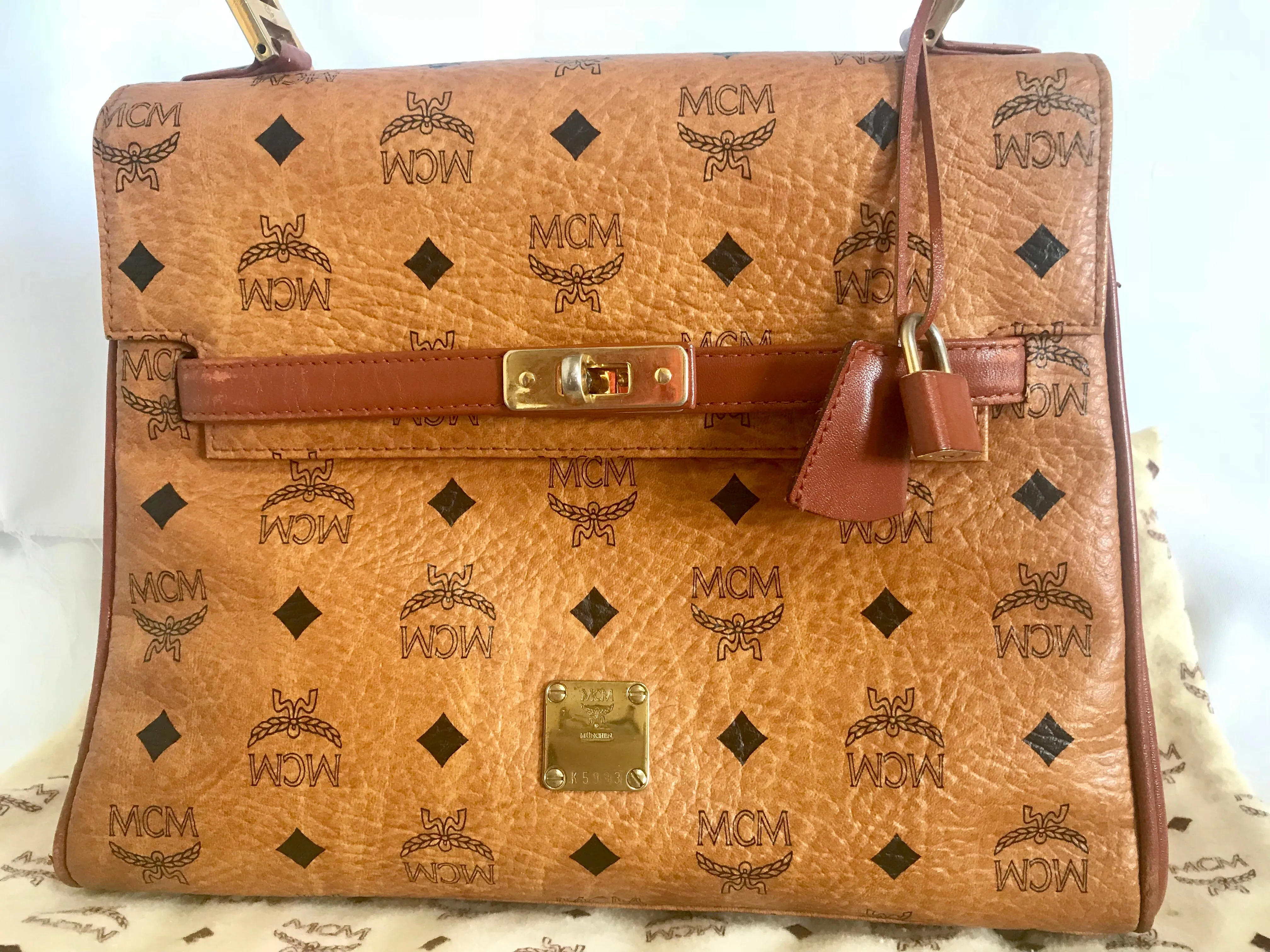 Vintage MCM classic brown monogram Kelly bag with golden logo plate. Perfect daily use bag.  By Michael Cromber, Germany